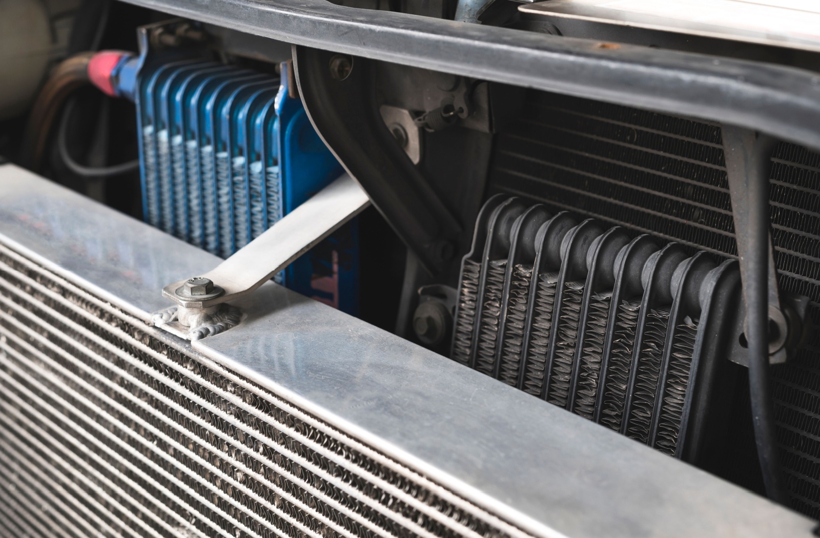 Close-up of an engine oil cooler on the front of a truck.