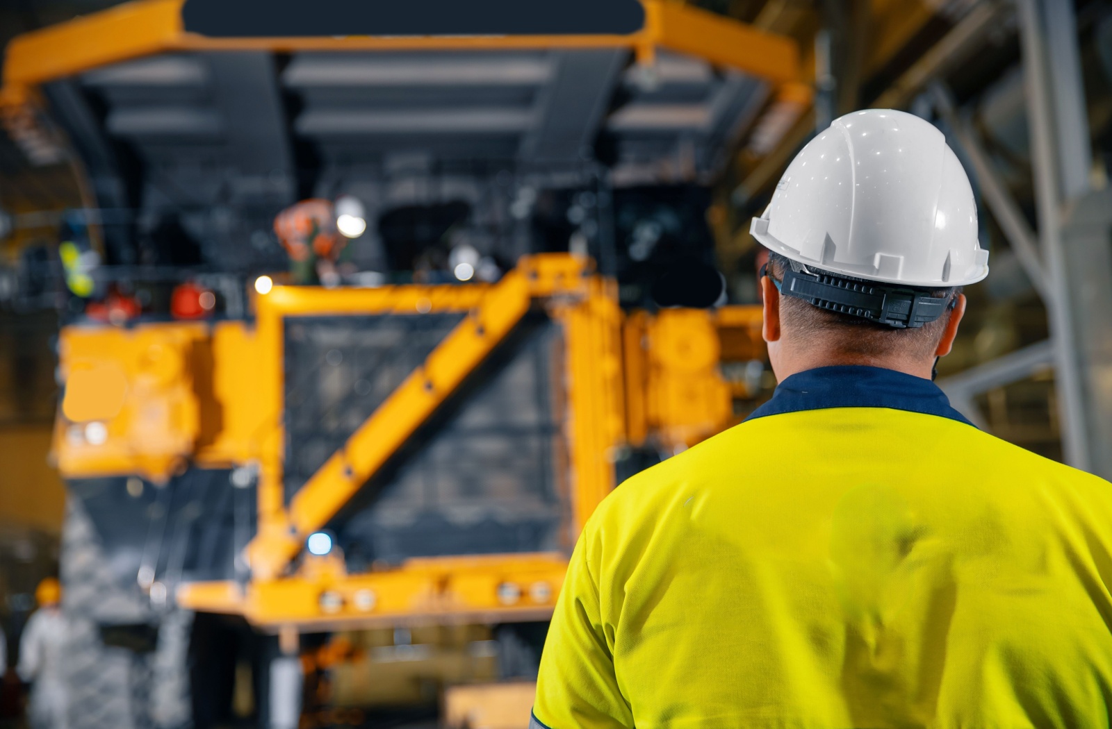 Technician getting ready to repair a mining dump truck in the shop.