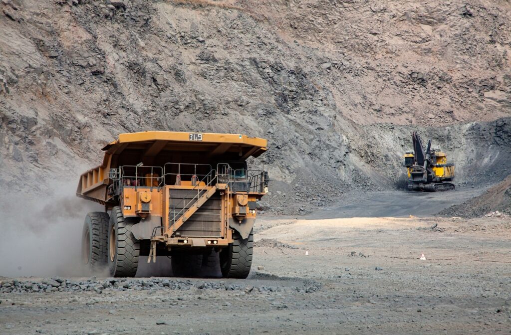 Large industrial equipment at work in rough, dusty conditions to highlight the importance of regular maintenance on their cooling systems.
