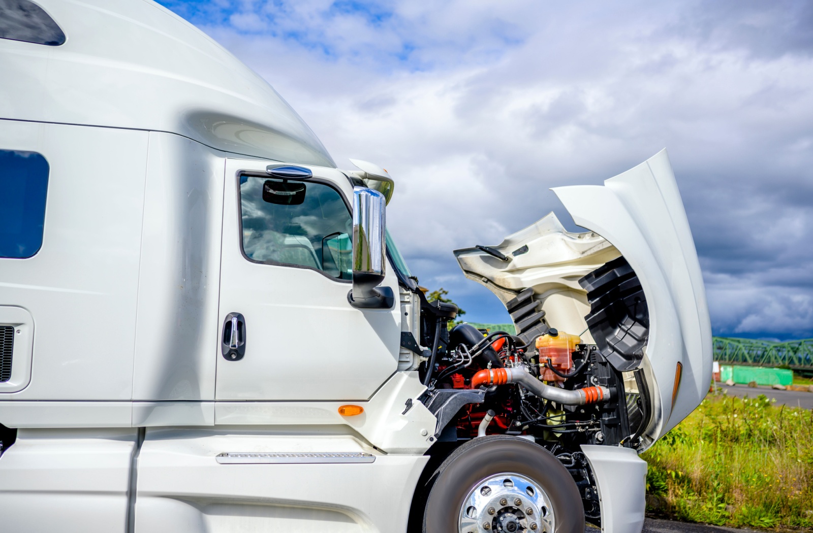 A semi truck broken down and requiring roadside repairs.