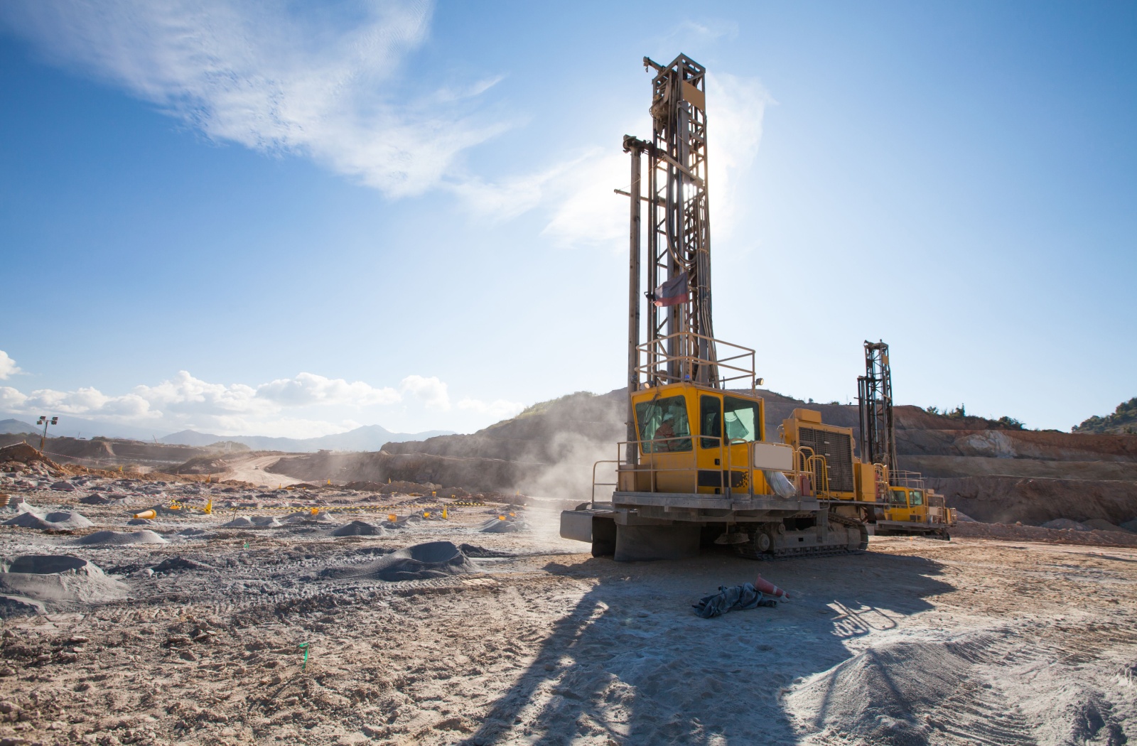 Yellow industrial drilling machine operating on a dusty construction site under a clear sky, symbolizing the heavy equipment and cooling systems Northland Radiator repairs and supports.