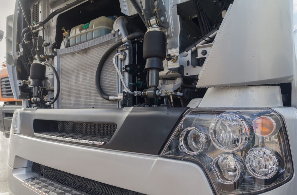 Close-up view of a heavy-duty truck with the front panel open, showing the radiator and cooling system components.
