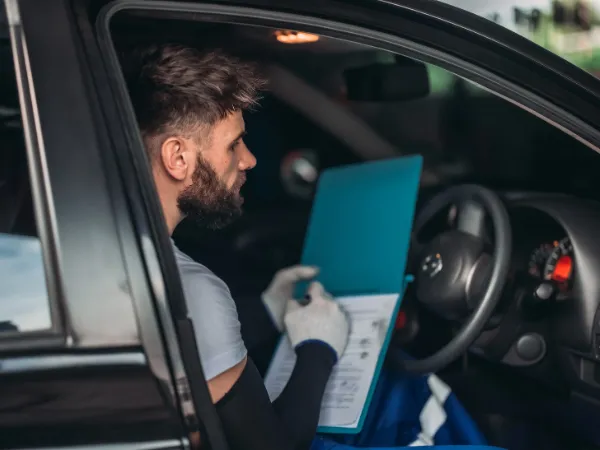 Heaters provide warmth as a man reviews documents in a car while wearing gloves