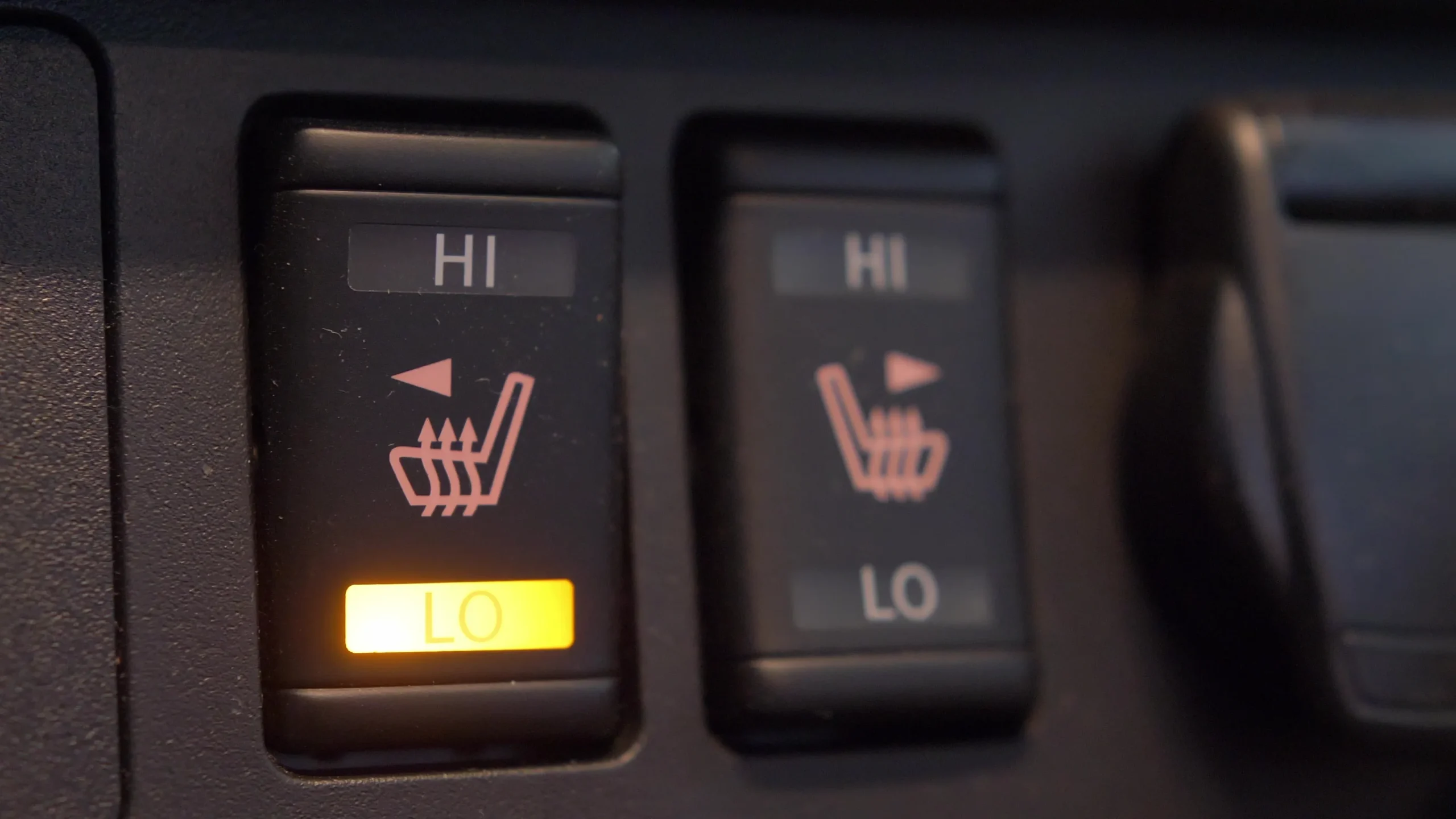 Heaters with illuminated low setting buttons for heated seats